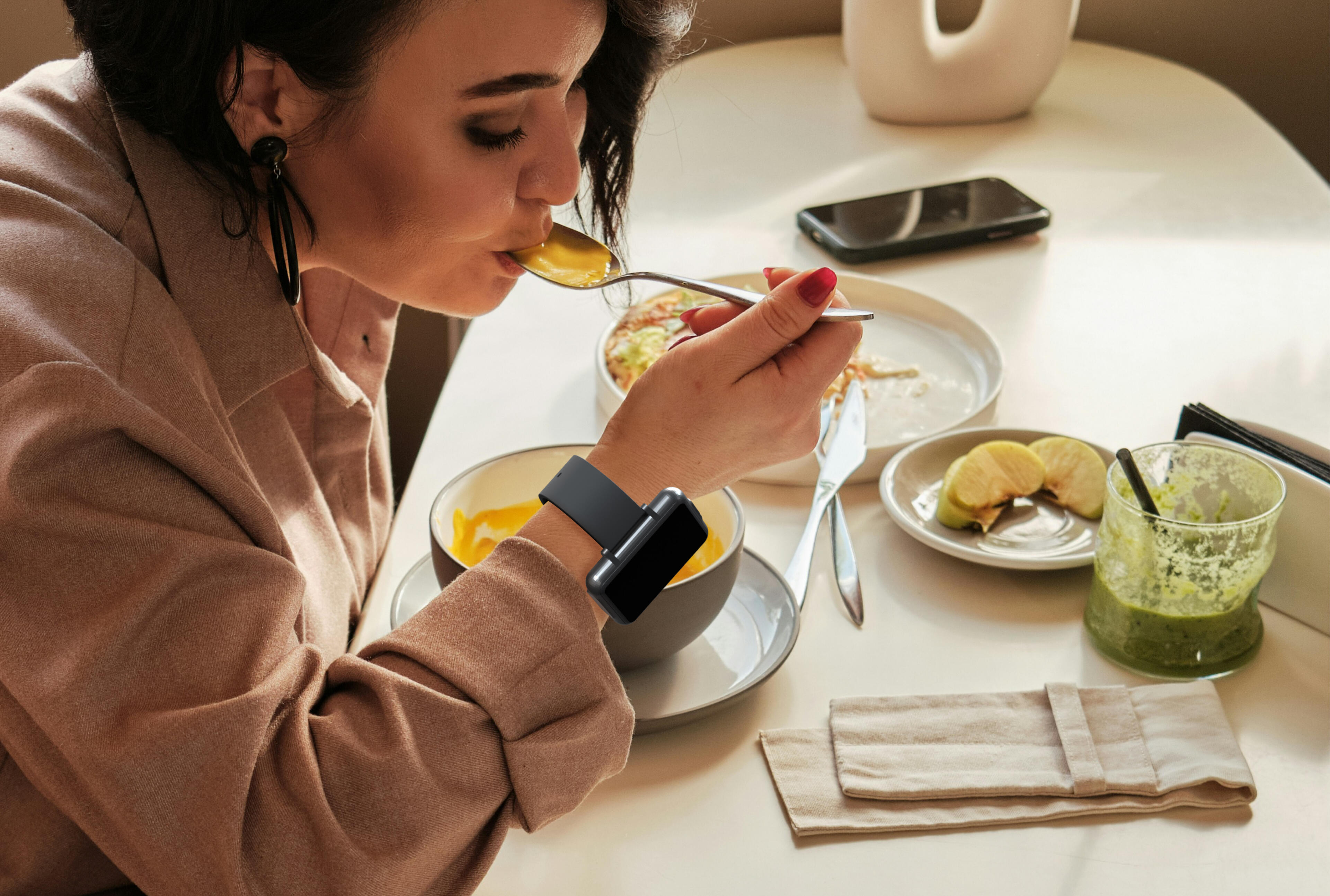 Woman eating soup while wearing the Cadence band. Woman eating soup while wearing the Cadence band.